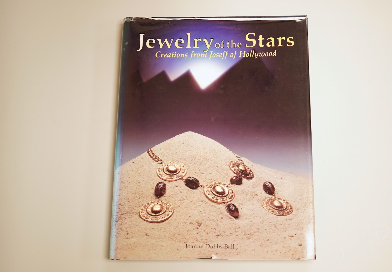 A mid 20th century North American gilt metal bee brooch by Joseff, wing span 30mm, together with a hard back copy of 'Jewelry of the Stars, Creations from Joseff of Hollywood' by Joanne Dubbs Ball.